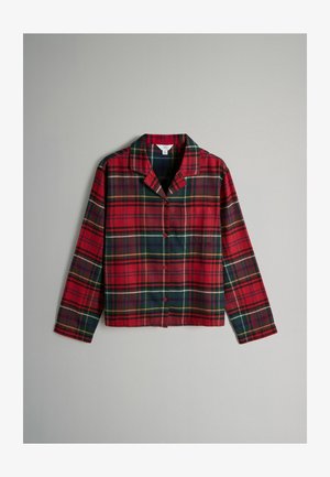 Camicia in flanella a quadri rossa e verde con maniche lunghe, collo a camicia e chiusura frontale con bottoni. Presenta una tasca sul petto.