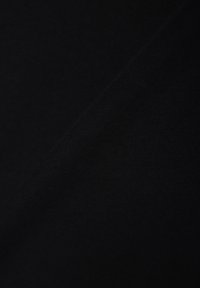 Black fabric with a smooth texture and subtle ribbed pattern, displaying two overlapping sections that create depth.