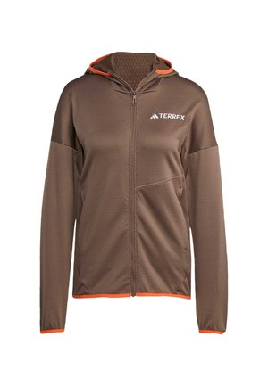 Brun zip-up jakke med sekskantet tekstur, oransje detaljer på hetta og nederste kant, samt en frontlomme. Har et logo på brystet.