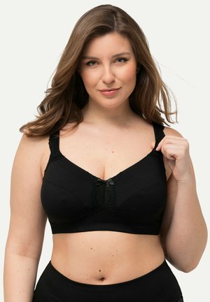 Soutien-gorge noir en tissu doux avec des accents en dentelle, design en V, bretelles réglables et un petit nœud décoratif au centre devant.