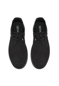 Chaussures noires à lacets avec une texture perforée, une forme arrondie et une semelle contrastante cousue. La doublure comprend une semelle intérieure à logo.