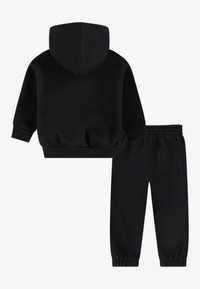 Black hoodie and sweatpants set, made from soft fabric. Features a hood, ribbed cuffs, and elastic waistband for comfort.