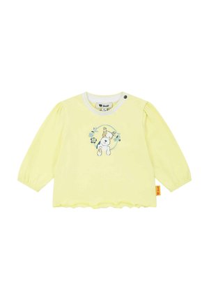 Gelbes Langarmshirt aus weichem Stoff, mit einem Hasen- und Blumendesign auf der Vorderseite, gewelltem Saum und einer Knopfverschluss.