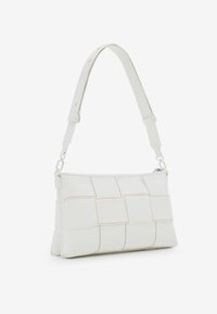 White leather shoulder bag with quilted pattern, red stitching accents, rectangular shape, and an adjustable strap. Zippered closure at the top.