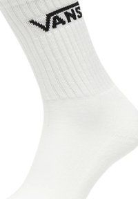 Calzino bianco alla caviglia con texture a coste e logo "VANS" nero sulla parte superiore. Realizzato in materiale misto cotone per comfort e durevolezza.