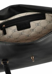 Black leather handbag with beige patterned fabric interior, featuring a zippered pocket and a gold-tone clasp on the outside.