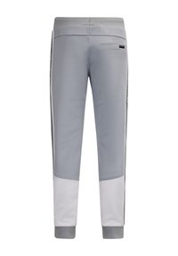 Grijze sportieve broek met een tapering pasvorm, voorzien van een textuur in het witte onderste gedeelte, zijstreepdetail en een achterzak.