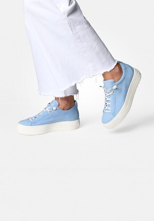 Lichtblauwe leren sneakers met witte rubberen zolen, met een vetersluiting, metalen oogjes en een gladde textuur.