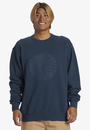 Navy blue sweatshirt in soft material featuring a circular design made of repeated text. Ribbed collar and cuffs add texture.