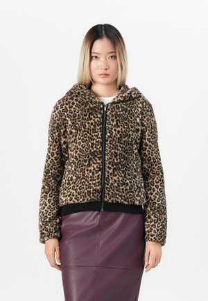 Leopard print zip-up jacket with a soft, textured fabric, hood, and ribbed black cuffs; paired with a purple leather skirt.