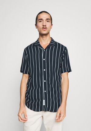Short-sleeve shirt in dark navy with vertical white stripes, button-up front, fold-down collar, and a relaxed fit. Flat fabric texture.