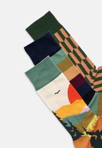 Vier Paar Socken mit verschiedenen Designs: grün, marineblau, gemustert und mit Landschaftsdrucken in Farben wie Orange, Gelb und Grün.