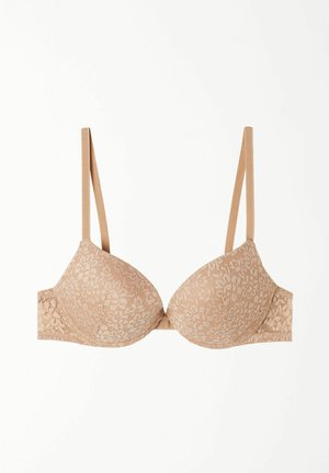 Spitzen-BH in Nude-Farbe mit geformten Cups, verstellbaren Trägern und einem Rückenverschluss. Das Design weist florale Muster und eine glatte Textur auf.
