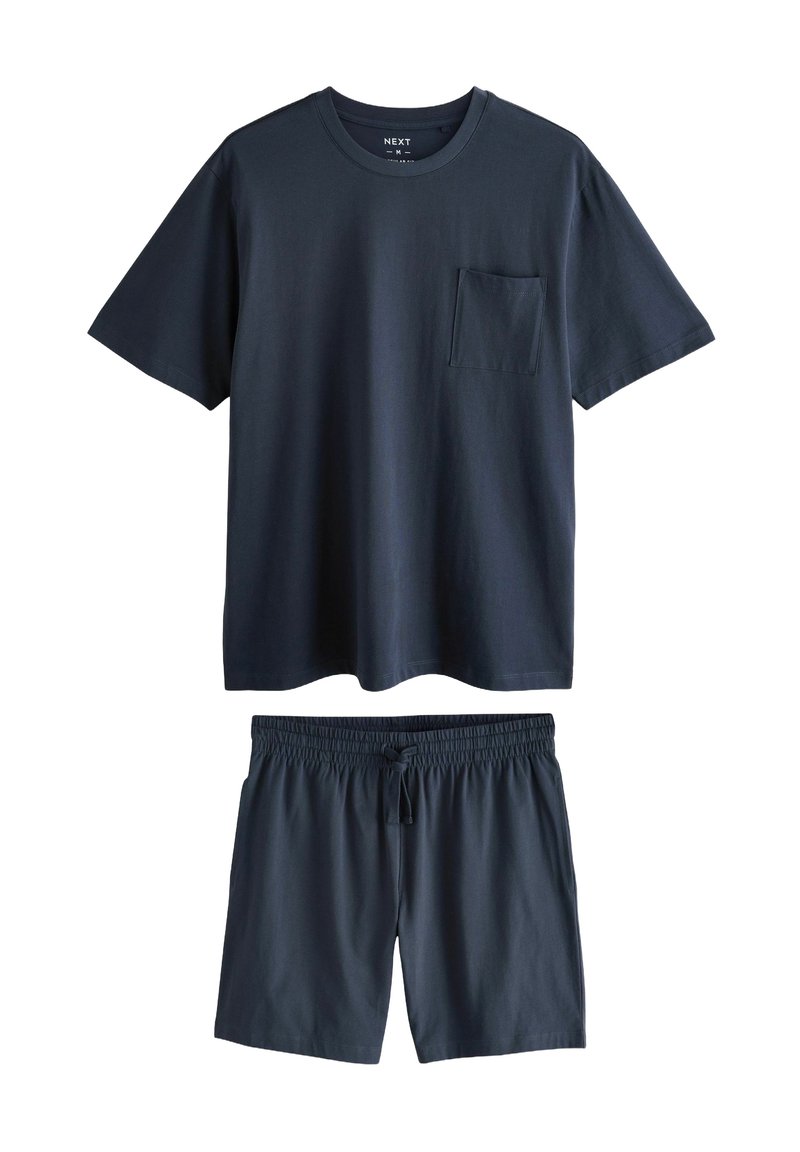 Marinblå bomulls-T-shirt med ficka; ihopparat med matchande shorts med elastisk midja och snörning. Slät textur.