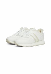 White sneakers with faux fur lining, smooth leather upper, three vertical stripes in light cream, and a cushioned sole.