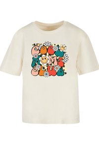 Cream-colored t-shirt featuring a colorful graphic with the text "Cool Moms Club," daisies, and smiley faces on a leopard-print background.