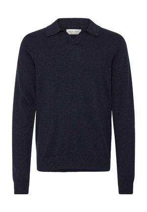 Tumši zils pulovers ar V veida izgriezumu un īsu apkakli. Izgatavots no mīksta auduma, ar garām piedurknēm un ribotām aprocēm un apakšmalu.