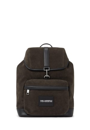 Dark brown suede backpack with black leather trim, front zip pocket, metal buckle closure, and Karl Lagerfeld logo patch on pocket.
