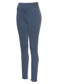 Leggings de mezclilla azul oscuro con una textura suave, cintura alta y un sutil detalle de costura en forma de V. Cuenta con un pequeño acento de logo cerca de la cinturilla.