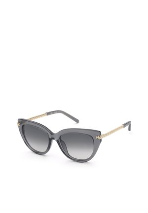 Lunettes de soleil œil de chat noires avec verres gris dégradés et branches dorées texturées.
