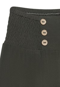 Dark green pants with a smocked waistband featuring three natural wood buttons and a smooth texture. Tailored for comfort and flexibility.