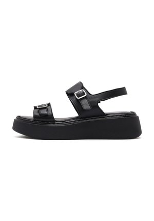 Zwarte leren platform sandalen met dubbele banden en gespaccenten, een platte zool en een geprofileerde binnenzool voor extra comfort.