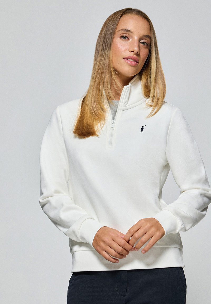 Witte fleece pullovertop met hoge kraag en ritssluiting aan de voorkant. Voorzien van ribgebreide manchetten en zoom. Geborduurd zwart logo op de borst.