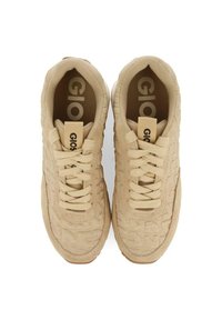 Zapatillas beige con tejido texturizado, punta redonda, cordones en la parte delantera y acentos de logo en la lengüeta. Suela de goma con un ligero patrón de agarre.