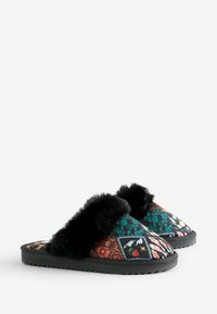Slippers with quilted multicolor patterns, black faux fur accents, and a textured black outsole. Open back design for easy wear.