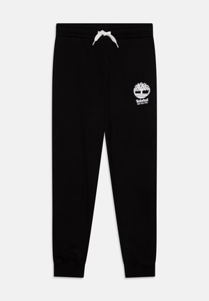 Pantalons de jogging en coton noir avec un logo Timberland blanc. Dotés d'une taille à cordon de serrage et de poignets ribbés aux chevilles.