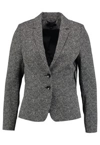Blazer à motif pied-de-poule noir et blanc, avec un col à revers, deux boutons et deux poches avant. Coupe ajustée avec manches longues.