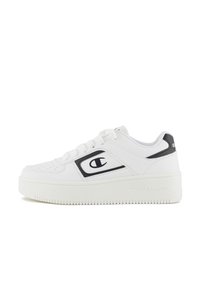 White sneakers with a smooth leather upper, black accents, rounded toe, flat laces, and a textured, thick sole featuring a logo detail.