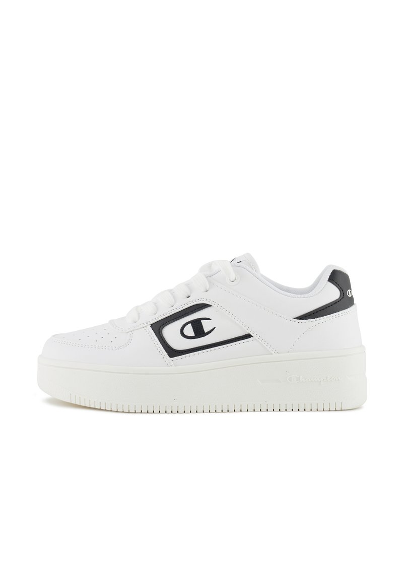 White sneakers with a smooth leather upper, black accents, rounded toe, flat laces, and a textured, thick sole featuring a logo detail.