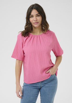 Ribbet rosa bluse med rund halsudskæring og korte ærmer. Har en afslappet pasform med sidelommer og en lidt længere bagkant.