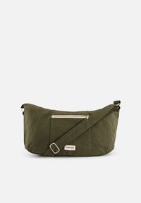 Sacoche verte olive en tissu texturé, dotée d'une poche zippée à l'avant, d'une sangle réglable et d'une petite étiquette sur le côté.