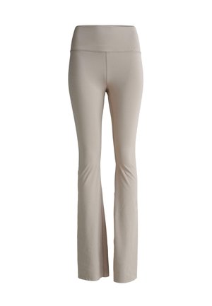 Leggings beige a palazzo realizzati in tessuto elasticizzato. Presentano una vita alta e una texture liscia, progettati per comfort e flessibilità.