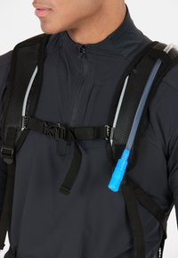 Hydration backpack with black mesh straps, adjustable buckle, and blue hydration tube extending from the side for easy access.