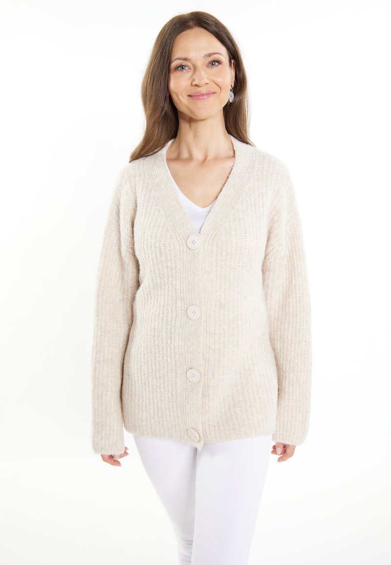 Cardigan beige lavorato a maglia con scollo a V, cinque bottoni sul davanti e maniche lunghe, caratterizzato da un motivo testurizzato e un tessuto morbido.