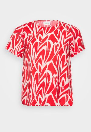 Červené tričko s krátkým rukávem, které má bílé abstraktní srdíčkové vzory. Je vyrobeno z měkké, lehké látky, má kulatý výstřih a volný střih.