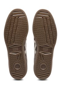 Pair of brown rubber-soled Onitsuka Tiger shoes showing detailed tread patterns and brand logo on the bottom.