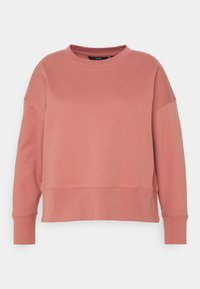 Sudadera rosa con cuello redondo, mangas largas y un corte relajado. Fabricada con un tejido suave, con puños acanalados y una textura suave.