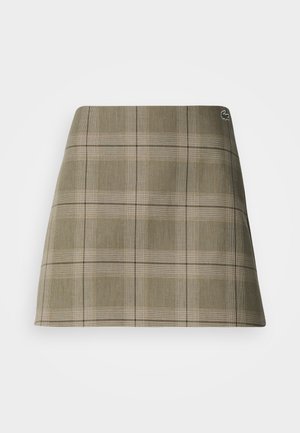 Olive roheline ja beež plaaditud mini seelik, millel on sirge lõige, peen tekstuur ja väike logo aktsent vöökohtade lähedal.