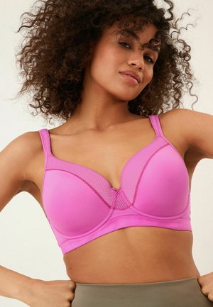 Pink bra with smooth microfiber cups and mesh accents at the center. Features adjustable straps and a seamless design for comfort.