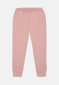 Rosa joggingsbyxor med en mjuk textur, elastiskt midjeband och smalnande muddar. Designen inkluderar sidoflikar för extra stil och komfort.