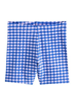 Blå og hvide ternede shorts med et let tekstureret mønster, lagt fladt mod en hvid baggrund.