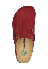 Red slip-on shoe featuring vertical ribbed texture, adjustable strap with black hardware, and a natural tan insole with a green spiral logo.