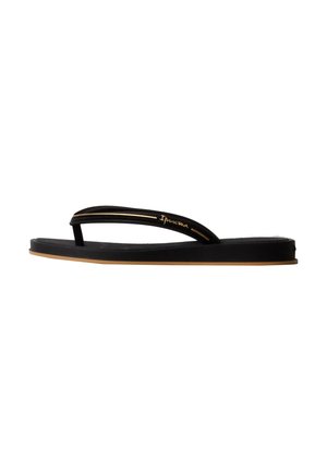 Sandale noire plate style flip-flop avec fines lanières et accents dorés, avec le nom de la marque Ipanema sur la lanière latérale.
