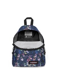 Mochila azul marino con estampado floral, cremalleras negras, correas acolchadas y un compartimento principal que revela un interior gris y etiqueta de cuidado.