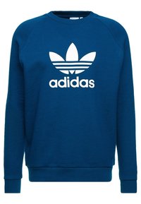 Sweatshirt bleu en coton avec un col ras du cou, arborant un grand logo Adidas blanc et le design emblématique à trois bandes sur les épaules.
