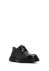 Chaussure habillée en cuir noir avec une finition lisse et brillante, bout rond, design à lacets et semelle en caoutchouc épaisse pour un bon amorti.